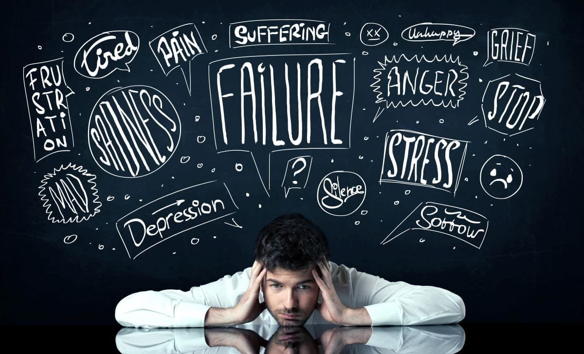 Man with anxious thoughts weighing over his head.