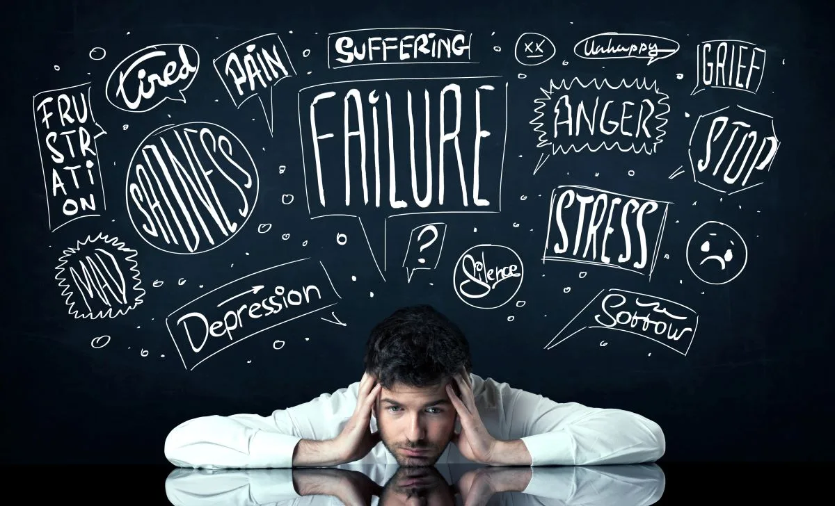 Man with anxious thoughts weighing over his head.