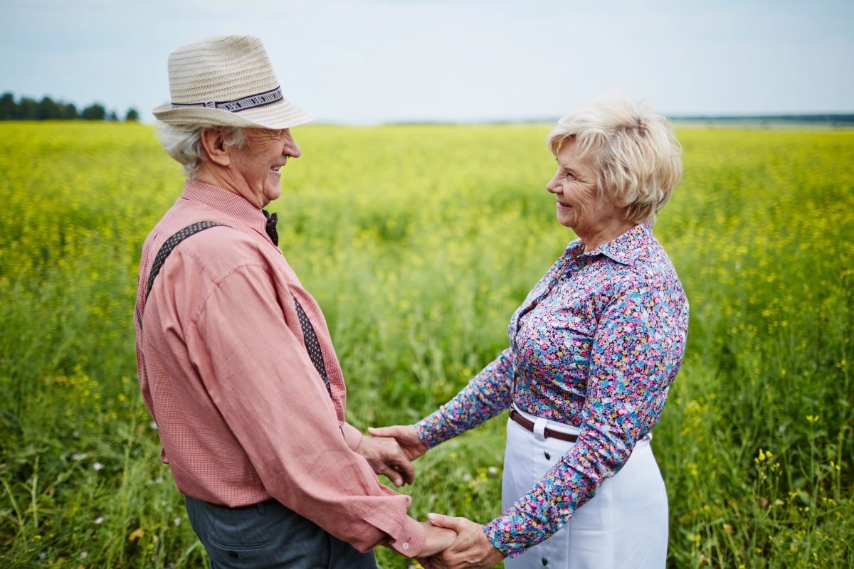 Older couple look at one another happily.