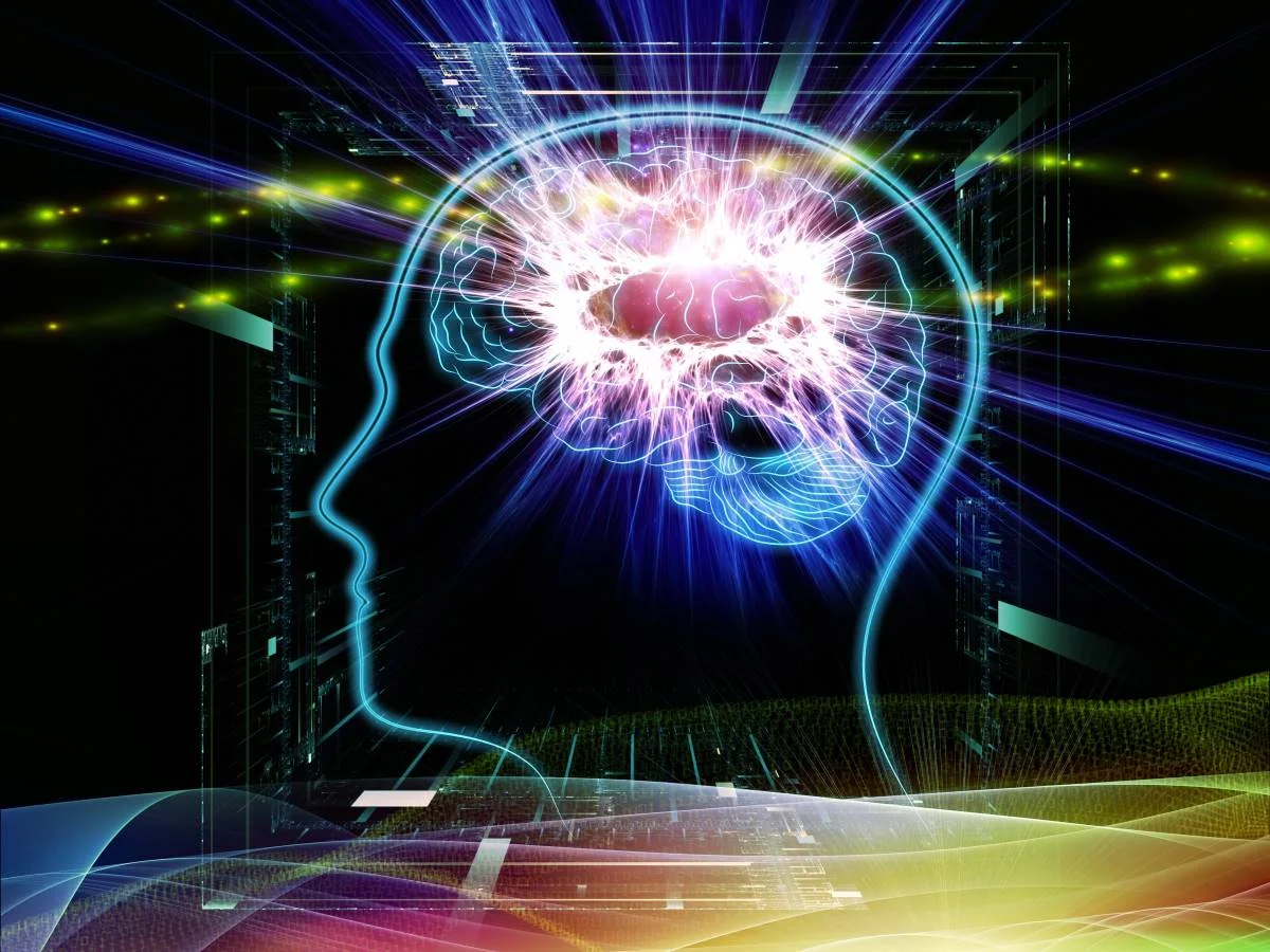 Abstract outline of a head with a lit up brain inside.